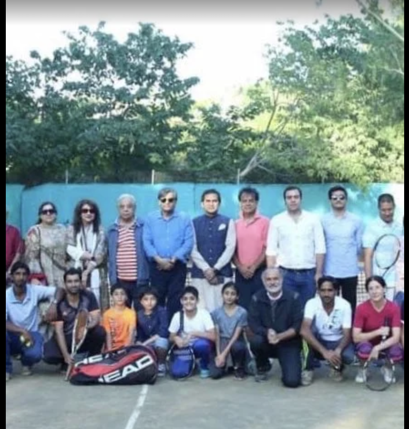 Members, juniors and guests of Margalla Tennis Club gathered on court for a group photograph